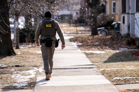 man wearing Ice vest walking down street in neighborhood
