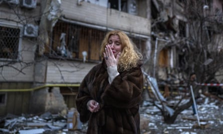 Natali Sevriukova reacts next to her house after a rocket attack on the city of Kyiv, Ukraine on 25 February