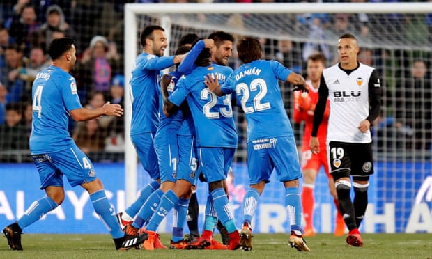 Getafe players celebrate after scoring the opening goal against Valencia.