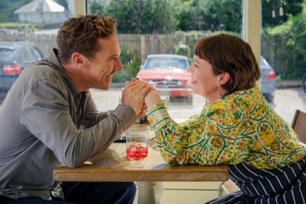 Benedict Cumberbatch and Olivia Colman hold hands across a cafe table in The Roses.
