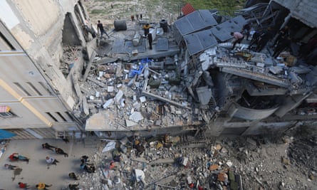 Palestinians inspect the destruction after the Israeli strike on a home in the Sabra neighbourhood in Gaza.