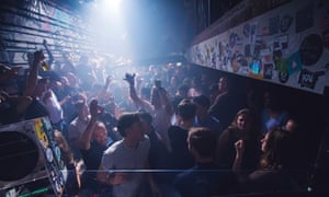 A packed dancefloor under strobing lights at Club NYX in Amsterdam.