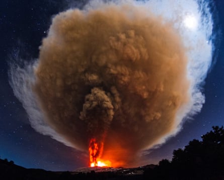 The ash cloud from Mount Etna’s Voragine crater lights up the sky.