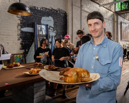 Nick Jordan holding a roast chicken on a plate