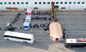 Canadian passengers are disembarked from the Grand Princess cruise ship at the Port of Oakland in California on March 9, 2020.