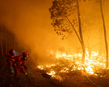 Members of the emergency military unit try to extinguish a wildfire in Ourense province, Spain, in August 2025.