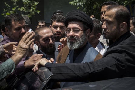 Mojtaba Khamenei stands in a throng of people