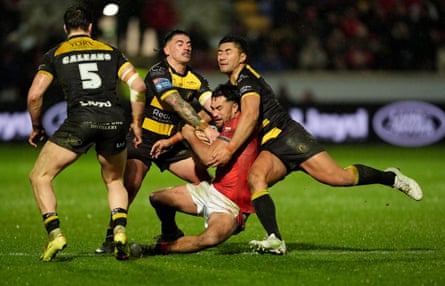 Hull KR’s Peta Hiku (centre) is tackled by York Knights’ Nikau Williams (left) and Ata Hingano (right).