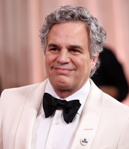 Mark Ruffalo wears a white dinner suit with black bow tie and a ‘Be Good’ badge