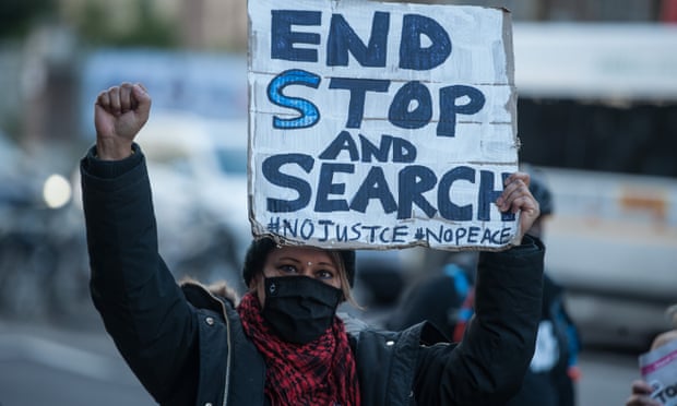 A demonstrator holds a placard at a protest against the misuse of stop and search powers in London