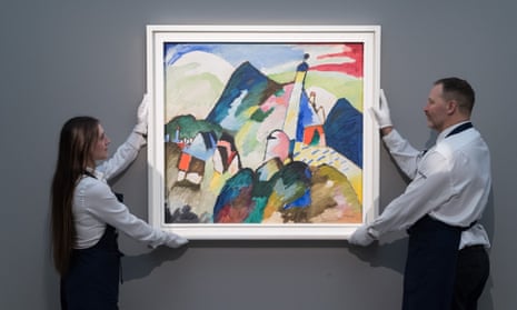 Art handlers display the Wassily Kandinsky painting Murnau mit Kirche II from 1910 at Sotheby’s auction house in London