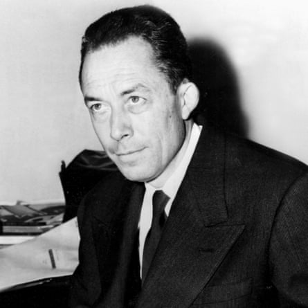 Albert Camus in a black suit and black tie