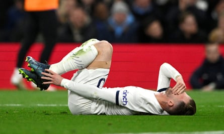 James Maddison lying on the pitch holding an ankle.