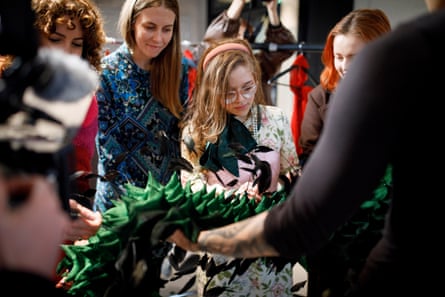 Designer Chet Lo shows the fabrics and explains the garments to guests in a touch tour.