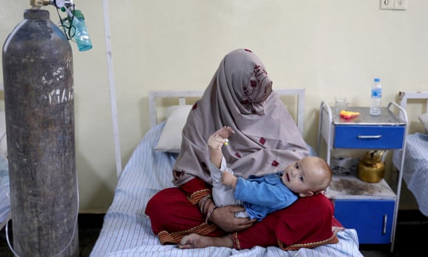 A woman holds her baby inside a hospital in Sharana, Afghanistan after the child was injured in earthquake.