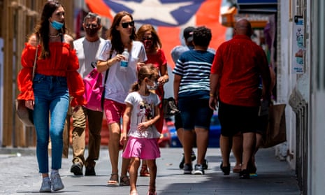 Tourists walk down a street in Old San Juan, Puerto Rico.