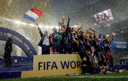 Didier Deschamps waves a flag as Hugo Lloris lifts the trophy after the 2018 World Cup final victory over Croatia