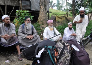 Muslim missionaries called ‘Tablighi’ are seen with their belongings as they await transport out of Marawi