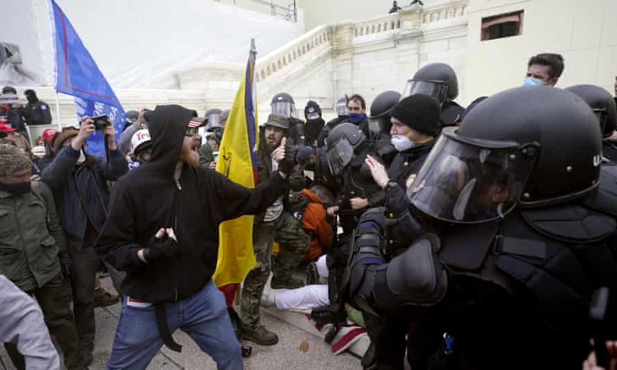 Rioters try to break through a police barrier, 6 January at the Capitol in Washington.