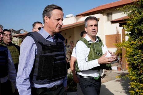 David Cameron viewing a home destroyed in last month’s Hamas attack, with the Israeli foreign minister Eli Cohen (right).