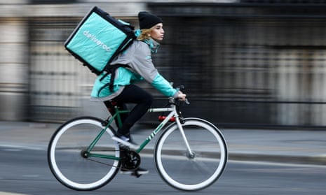 A cyclist delivers food for Deliveroo in London. A quarter of gig economy workers earn less than the mandatory £7.50 per hour, government research shows.