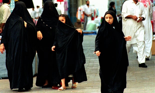 Two Saudi women and two young girls wearing abayas. 