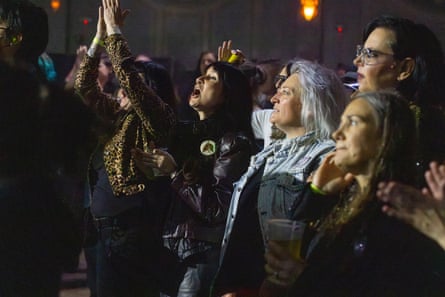 Middle aged women listen to musicians perform