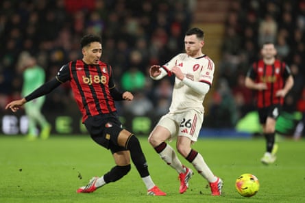 James Hill (left) challenges Liverpool's Andrew Robertson for the ball