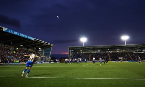 The floodlights are on at the New Meadow during a Shrewsbury Town match in August