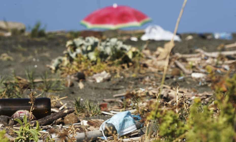 A face mask on a rubbish-strewn beach in Fiumicino, near Rome. Italy produced 10% less litter during its coronavirus lockdown.