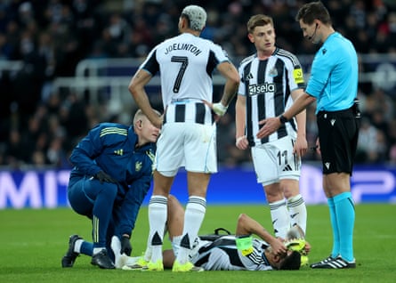 Bruno Guimarães lies injured during Newcastle’s game against PSV Eindhoven in the Champions League.