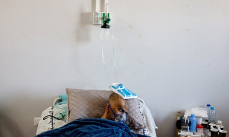 A Palestinian cancer patient wearing oxygen man receives treatment at Nasser hospital in Khan Younis 
