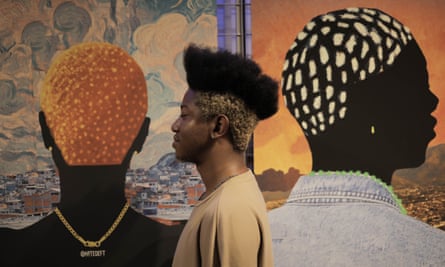 Man stands beside artwork of two figures, one facing away, one with head to the side
