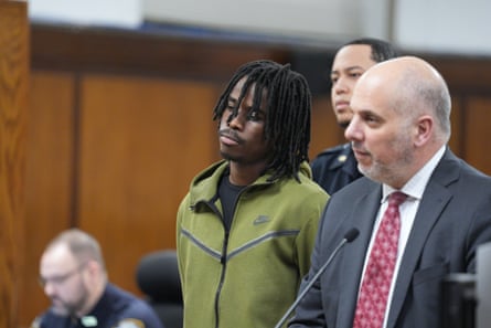 A man stands next to his lawyer in court
