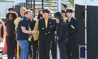 James Corden is seen with J-Hope, Jin, Jimin, V and Jungkook of the K-pop band BTS during the filming of The Late Late Show With James Corden in 2021.