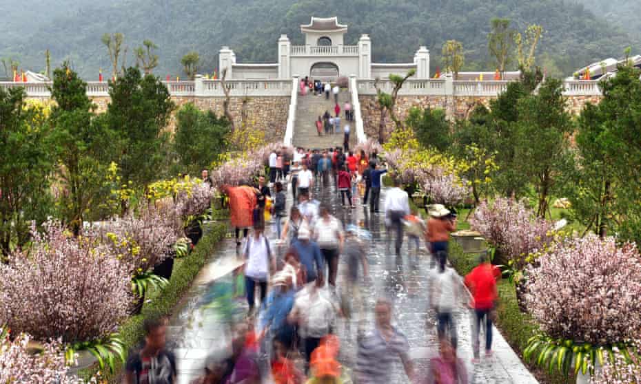 visitors approaching the entrance to the new complex, designed to look like a 13th-century village, near Yen Tu, Vietnam.