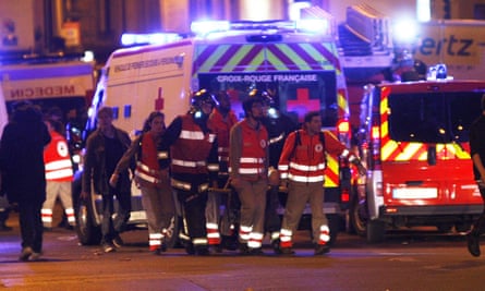Rescue workers evacuate an injured person on Rue de Charonne.