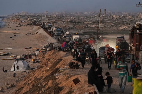 Displaced Palestinians flee northern Gaza along the coastal road toward the south on Tuesday.