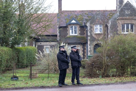 Two police officers stood outside a building.