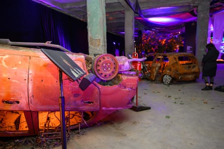 an exhibition shows damaged, overturned cars