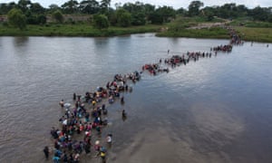 Salvadoran migrants heading in a caravan to the US, crossing the Suchiate river to Mexico from Guatemala, on 2 November. 1334.jpg?width=300&quality=85&auto=forma