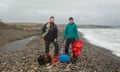 Eco Dewi Beach Cleaners pictured at Newgale beach in North Pembrokeshire.<br>From left to right: Jeremy Wadia (Director of the community interest company) and Katy Fox (Director of the community interest company), stand at the northern end of Newgale Beach in North Pembrokeshire, holding refuse bags, litter pickers, and collected beach debris and rubbish.