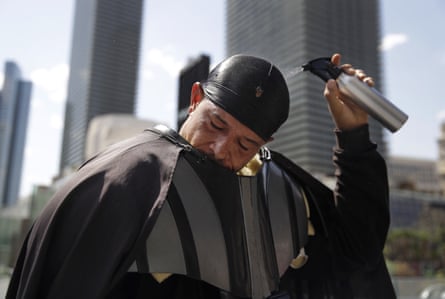 Chris Mitchell, wearing a Darth Vader costume, pours water over his head to cool off along the Las Vegas Strip, 20 June 2017