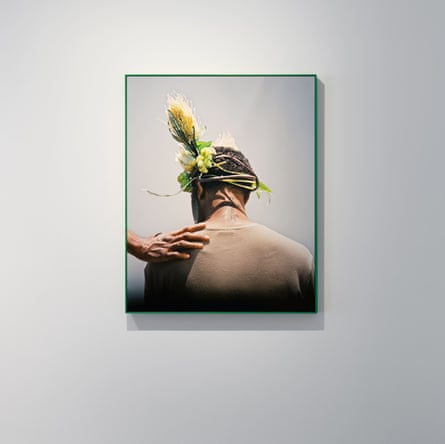 Artwork by Hoda Afshar: a man’s back, flowers woven into his hair, a hand on his shoulder