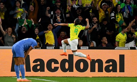 Debinha punches the air after making it 1-1 as Brazil fans celebrate in the background