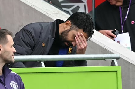 Ruben Amorim looks down, masking his eyes