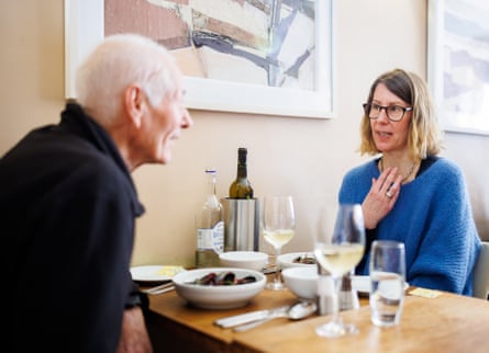 A man and woman facing each other across a restaurant table