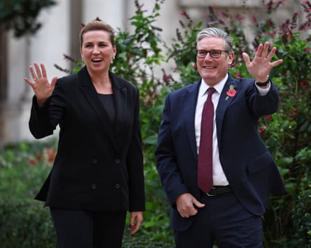 Mette Frederiksen, Denmark’s prime minister, and Keir Starmer, the UK’s prime minister, waving to the cameras