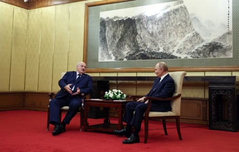 Belarusian President Alexander Lukashenko (L) and Russian President Vladimir Putin (R) speak during a meeting at the Diaoyutai State Guesthouse, one day ahead of China’s Victory Parade