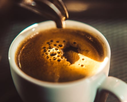 Espresso shot pouring out of a espresso machine.